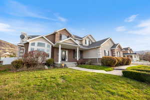 View of front of house with brick siding and a porch