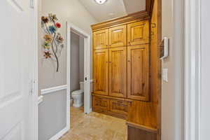 Bathroom with stone tile flooring and toilet