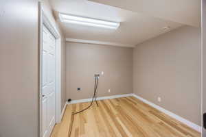 Basement featuring light wood-style flooring and baseboards