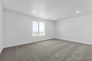 Unfurnished room with carpet, a mountain view, and recessed lighting