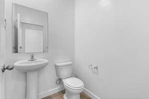 Bathroom featuring baseboards and wood finished floors