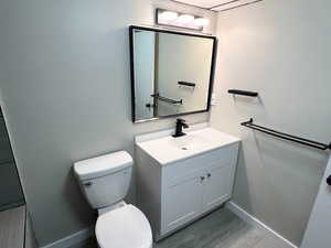 Half bath featuring vanity and light wood-style flooring
