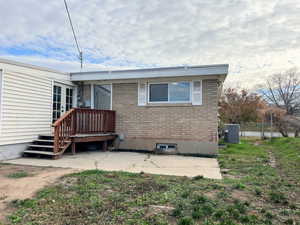 Back of property featuring brick siding