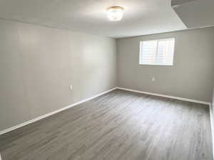 Spare room with wood finished floors and baseboards