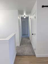 Hall featuring baseboards and light wood-style flooring