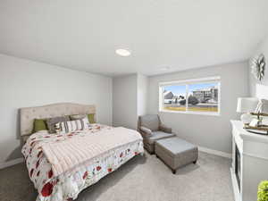 Bedroom featuring light colored carpet and a textured ceiling