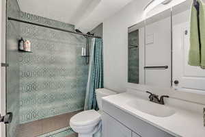 Bathroom with vanity, a stall shower, and a textured ceiling