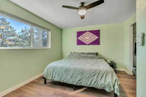 Bedroom with wood finished floors and a ceiling fan