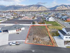Aerial view of residential area with property boundaries highlighted and mountains