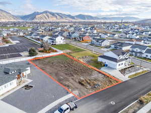 Aerial perspective of suburban area featuring mountains and property boundaries highlighted