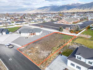 Aerial view of residential area featuring mountains and property parcel outlined
