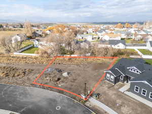 Aerial perspective of suburban area featuring property boundaries highlighted