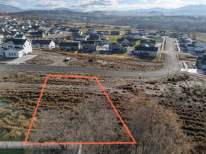 Aerial view of residential area featuring property parcel outlined and mountains