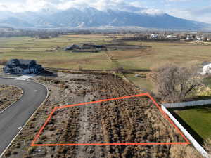 Overview of rural landscape with a mountainous background and property parcel outlined