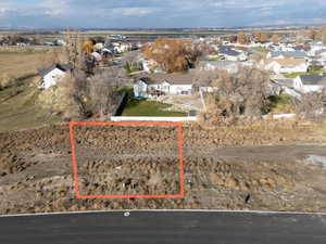 Aerial view of property and surrounding area featuring nearby suburban area and property boundaries highlighted