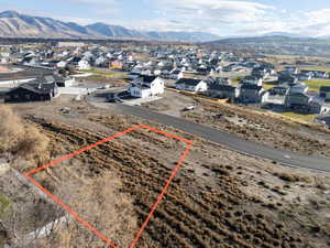 Aerial perspective of suburban area featuring mountains and property parcel outlined
