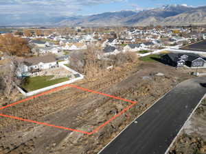Aerial view of residential area featuring property parcel outlined and mountains