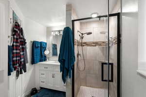 Full bathroom featuring vanity and a shower stall