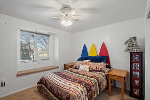 Bedroom featuring carpet flooring, ceiling fan, and a textured ceiling