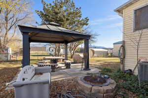View of patio / terrace with a fire pit and a gazebo