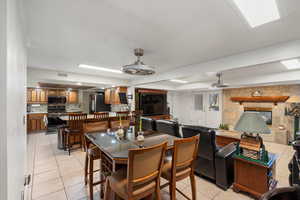 Dining room featuring light tile patterned flooring and a fireplace