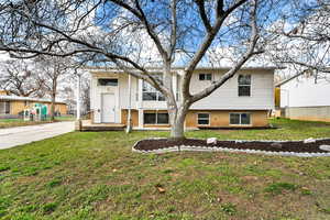 View of front of property with a front lawn and brick siding