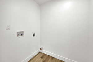 Laundry room with wood finished floors, hookup for an electric dryer, and hookup for a washing machine