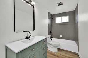 Full bath featuring vanity, light wood-style floors, and bathtub / shower combination