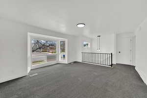Carpeted empty room featuring baseboards