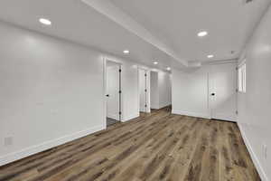 Finished below grade area with recessed lighting and light wood-type flooring