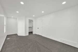 Unfurnished bedroom featuring recessed lighting, a spacious closet, and carpet flooring