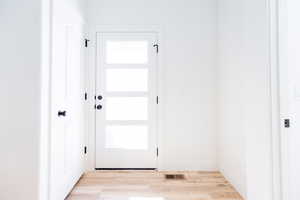 Photo of home built in past by OLO. . Entryway with wood finished floors and baseboards