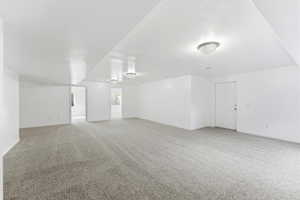 Family room with light carpet and baseboards