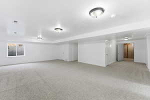 family room with light carpet and baseboards