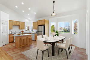 Virtually staged Dining area with recessed lighting, high vaulted ceiling, and light tile patterned flooring