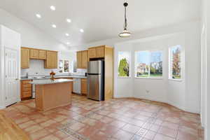 Kitchen with recessed lighting, white appliances, high vaulted ceiling, light countertops, and pendant lighting