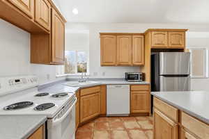 Kitchen with appliances with stainless steel finishes, light countertops, light tile patterned floors, and recessed lighting