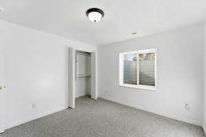 Unfurnished bedroom with a closet and carpet