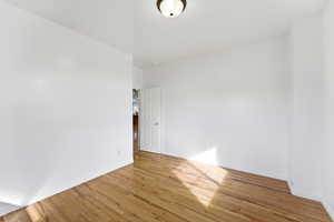 Unfurnished room featuring wood finished floors and baseboards