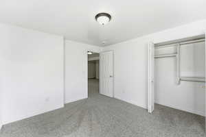 Unfurnished bedroom with carpet flooring and a closet
