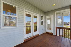 Covered wooden deck, Door to great room and door to primary suite.