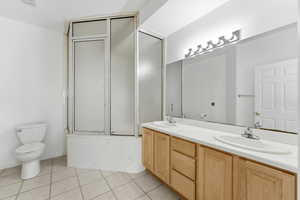 Primary Bathroom with double vanity and light tile patterned flooring
