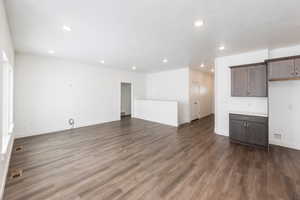 Photo of home built in past by OLO. Unfurnished living room featuring recessed lighting and dark wood finished floors