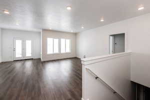 Photo of home built in past by OLO.  Room with dark wood-style floors and recessed lighting
