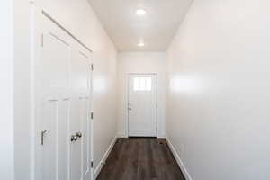 Photo of home built in past by OLO. Doorway to outside with wood finished floors and recessed lighting