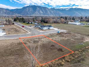 Aerial view of property's location with a mountainous background and property parcel outlined