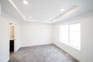 Photo of home built in past by OLO. Room featuring light colored carpet, recessed lighting, and a raised ceiling