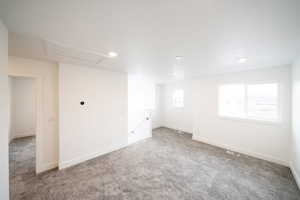 Photo of home built in past by OLO.  Carpeted spare room with baseboards and recessed lighting