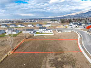 Aerial perspective of suburban area with property boundaries highlighted and mountains
