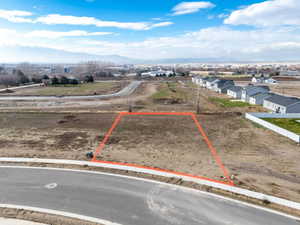 Aerial view of property's location with property parcel outlined and a mountainous background